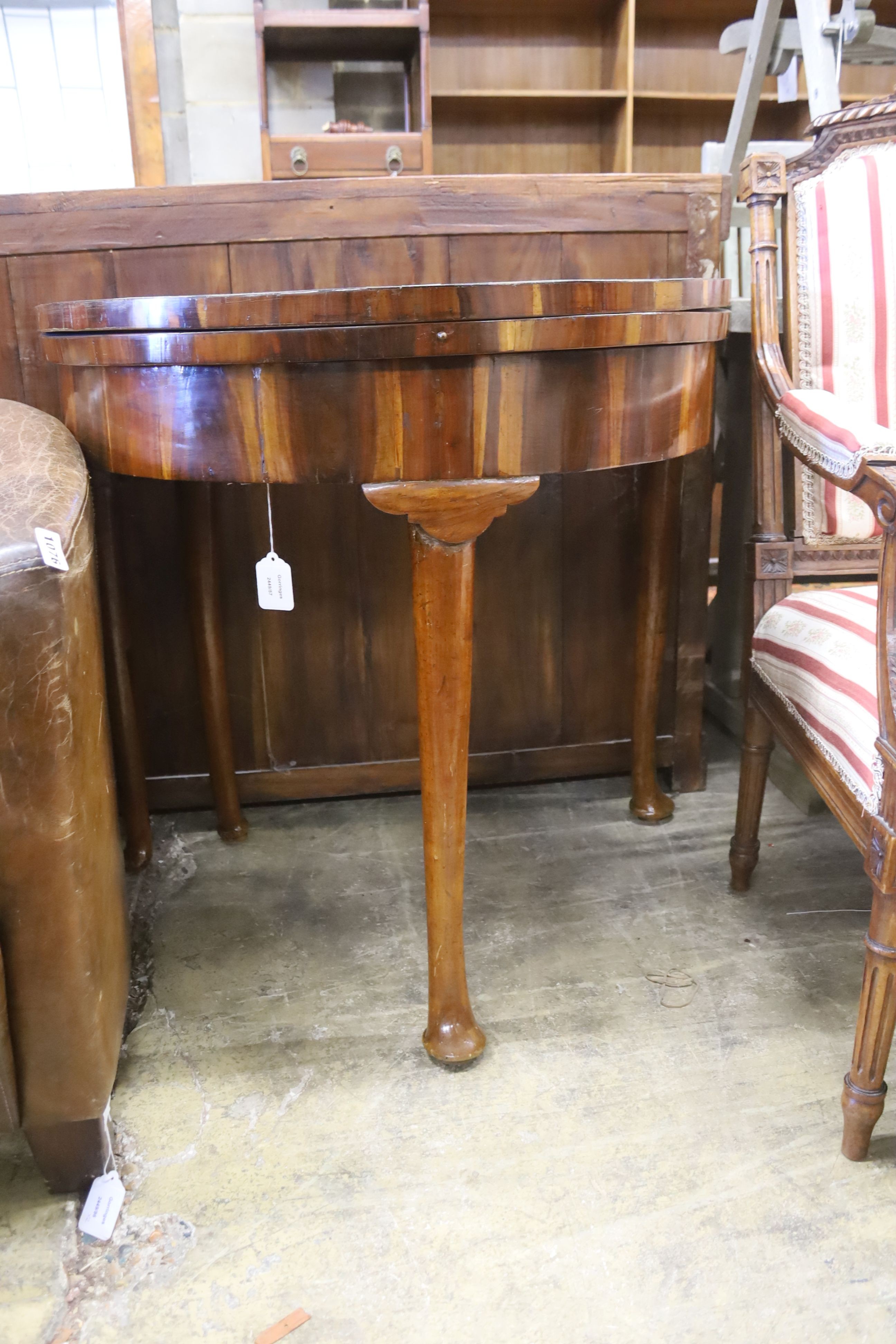 A 18th century Continental Goncalo Alves demi-lune card table with folding top, width 84cm, depth 56cm, height 76cm